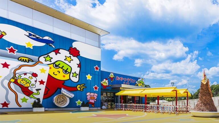 ホシオくんの大きな絵が描かれた建物と、黄色い屋根の入口